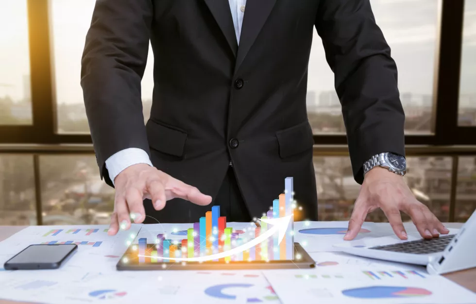 businessman-analyzing-graphs-with-technologic-devices