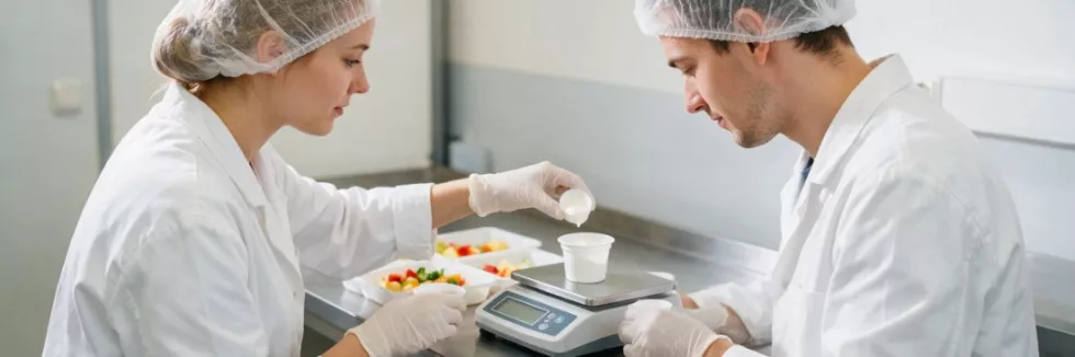food-scientists-weighing-yoghurt-samples-in-a-lab