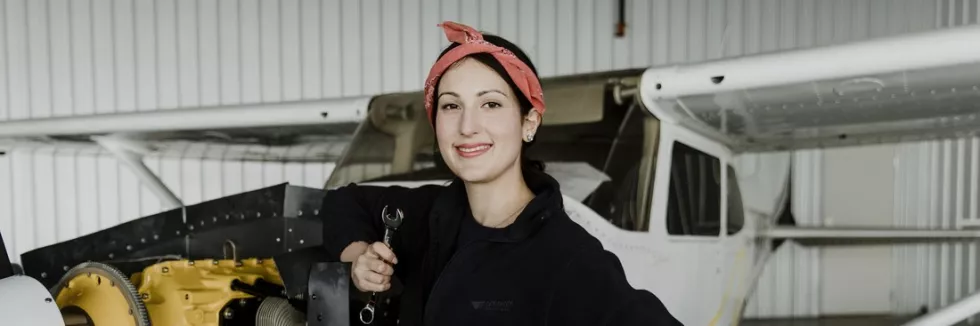 Aeronautics-and-Aerospace-Engineering-Masters-test-female-aviation-technician-repairing-the-motor-of-a-propelle