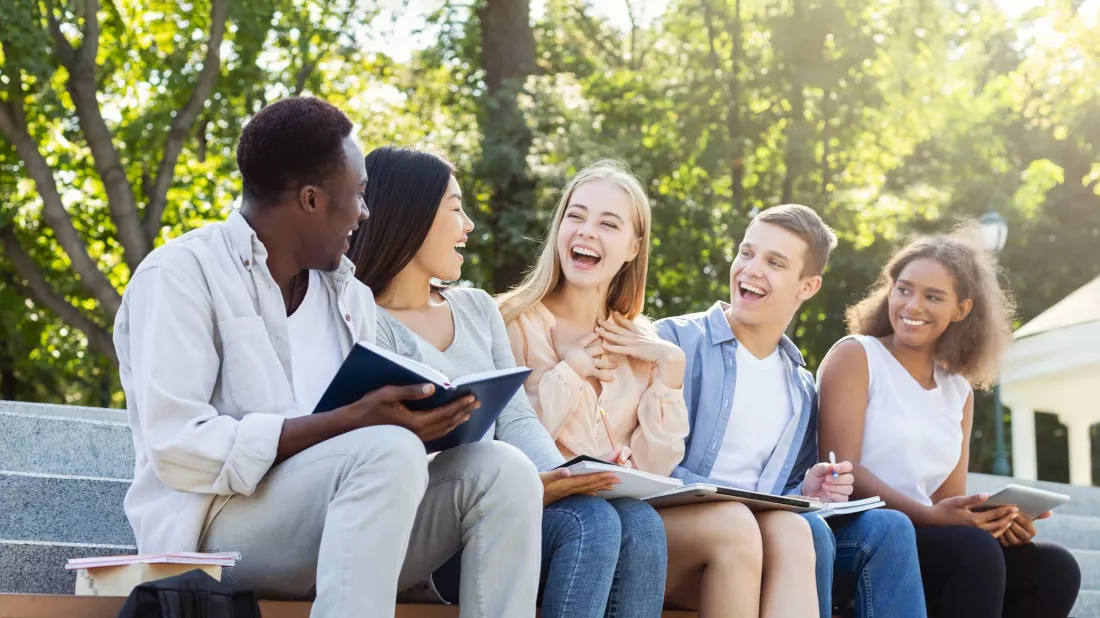 International students discussing a project on campus