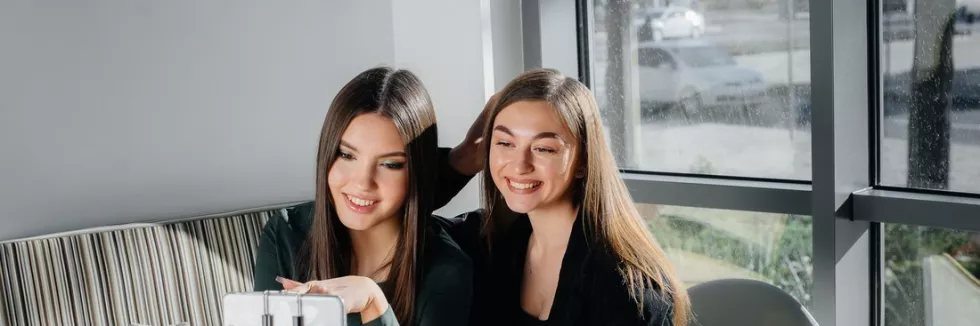 Bachelor-in-Management-and-Sociology-in-Business-and-Media-test-two-young-beautiful-girls-are-sitting-in-a-cafe-recording-vi