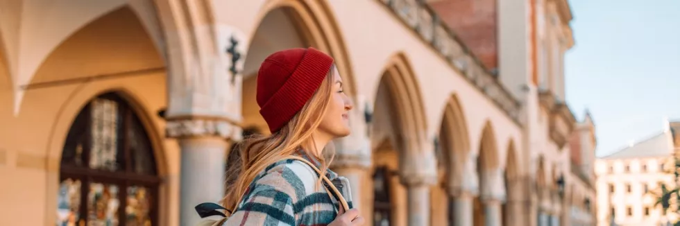 Central-Eastern-European-Studies-Masters-test-young-woman-tourist-in-red-cap-with-backpack-standing-travel