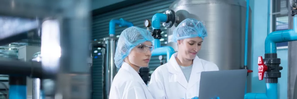 Circular-Economy-and-Water-Management-Masters-test-two-young-female-scientists-working-with-tablet-computer-in