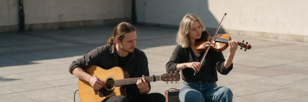 music-students-playing-guitar-and-violin-in-a-city-square