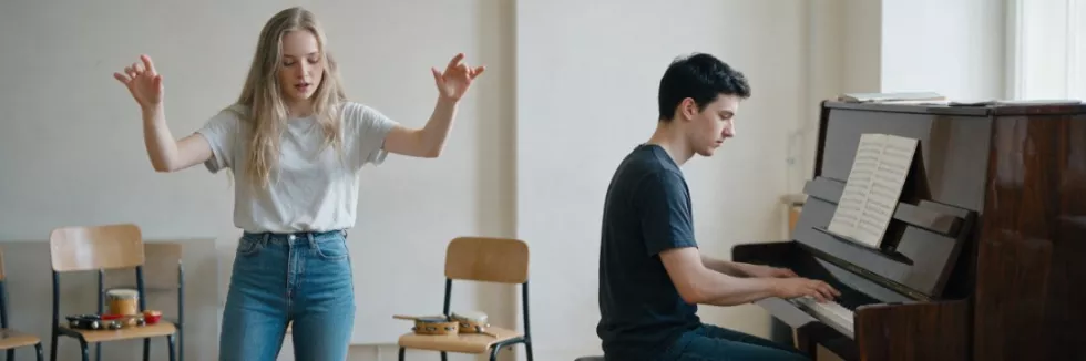 students-leading-a-music-workshop-at-a-piano