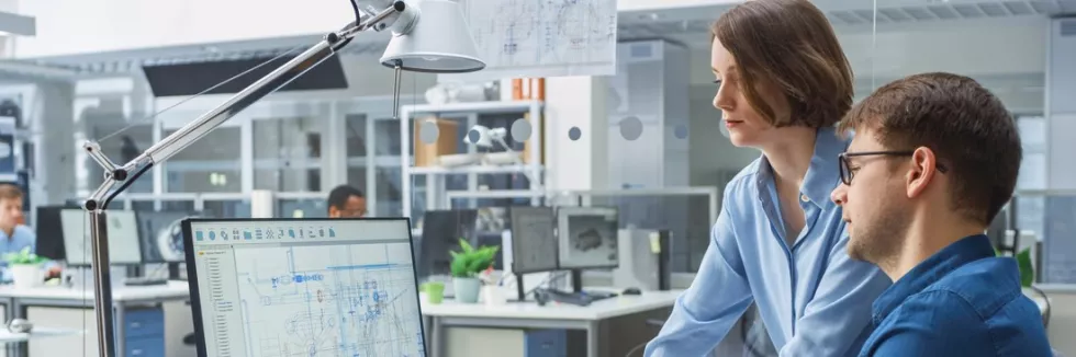 Computer-Modeling-in-Mechanics-program-test-engineer-talking-with-project-manager-and-working-on-desktop