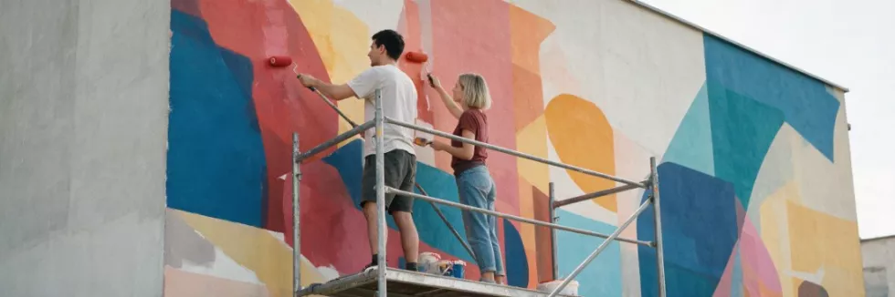 artists-painting-a-geometric-mural-on-a-building-wall