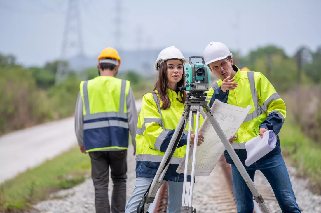 portrait-surveyors-wearing-uniform-conversation-notebook-blueprint-check-inspection-by-theodolite-camera-measurement-level-position-road-construction-site-is-industry-transportation-concept(1)