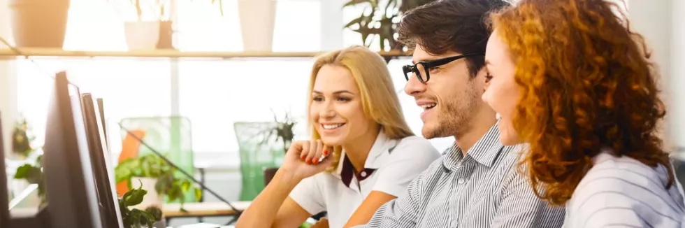 english-in-e-business-collaborative-team-on-laptops-at-trendy-workspace