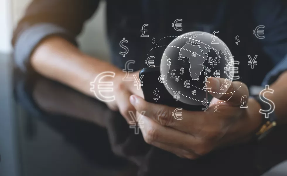 currency-exchange-money-transfer-fintech-financial-technology-etransaction-online-banking-interbank-payment-concept-man-using-mobile-phone-laptop-computer-with-global-currency