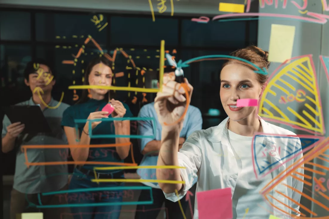 young-beautiful-businesswoman-writing-business-plan-glass-wall-tracery