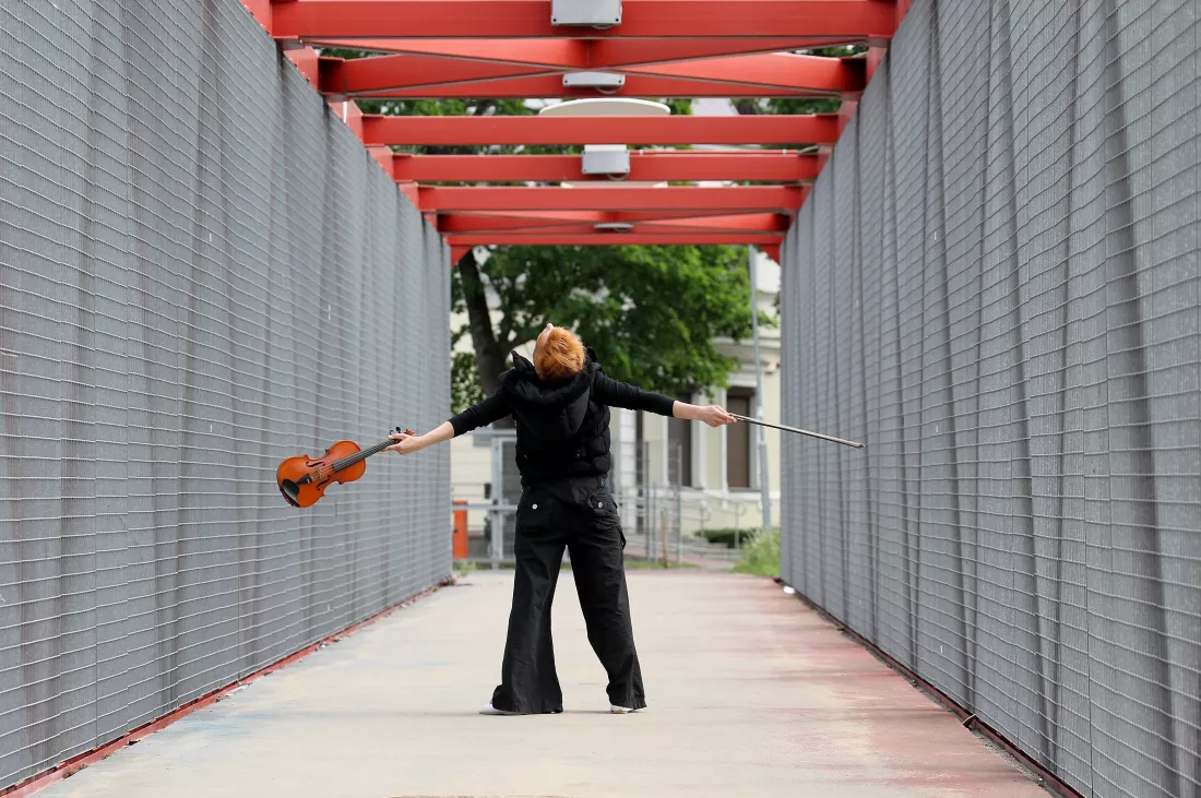 rear-view-man-standing-by-railing-against-building